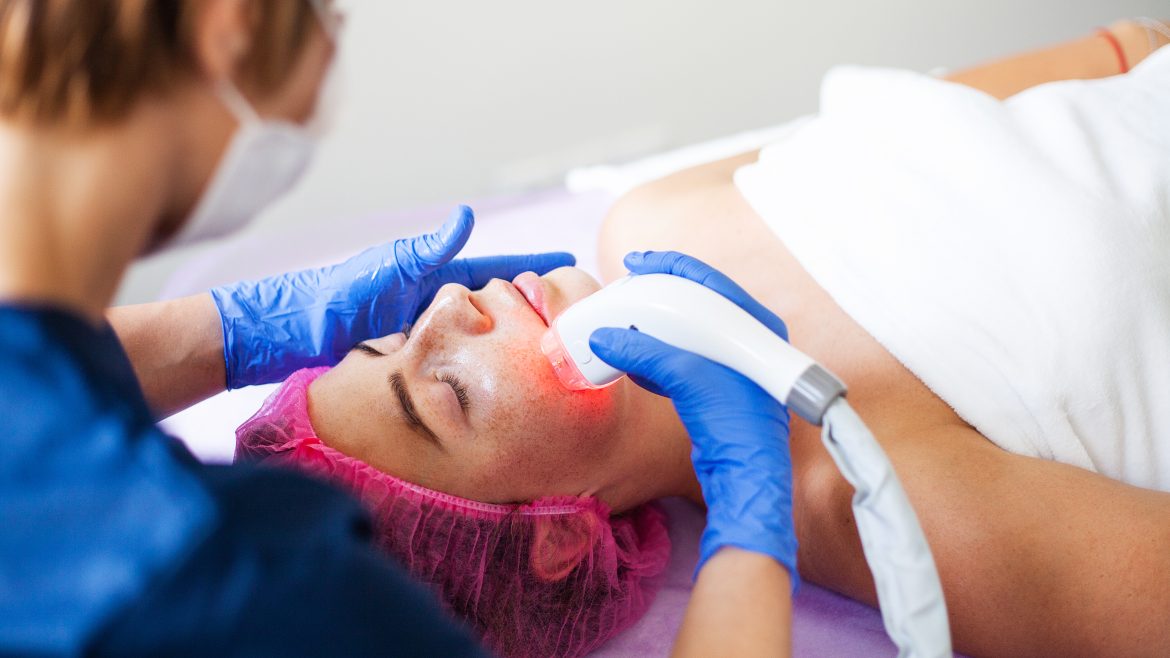 Woman getting LPG hardware massage at the beauty clinic. Professional beautician working